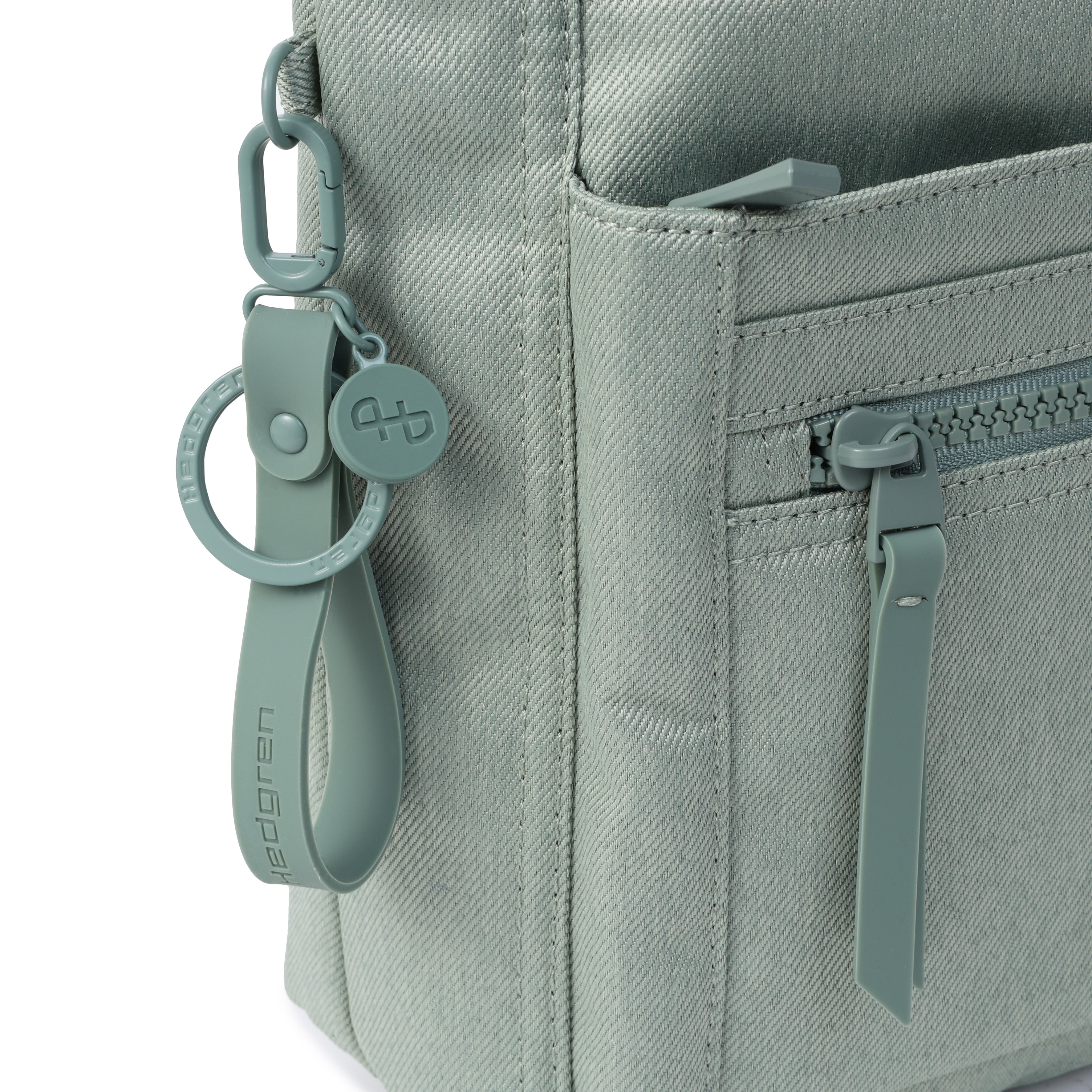 Close up of zipper on Orva RFID Crossbody #color_lily pad jean