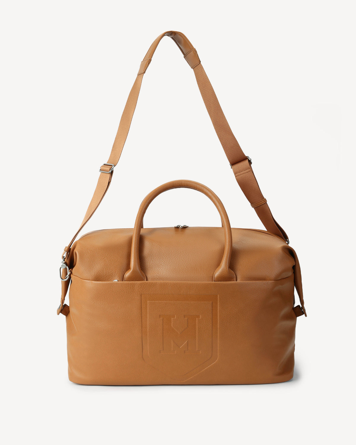 The Honorable Mention vegan leather bag with dual top handles, an adjustable shoulder strap, and an embossed 'M' logo on the front, shown against a plain light gray background.