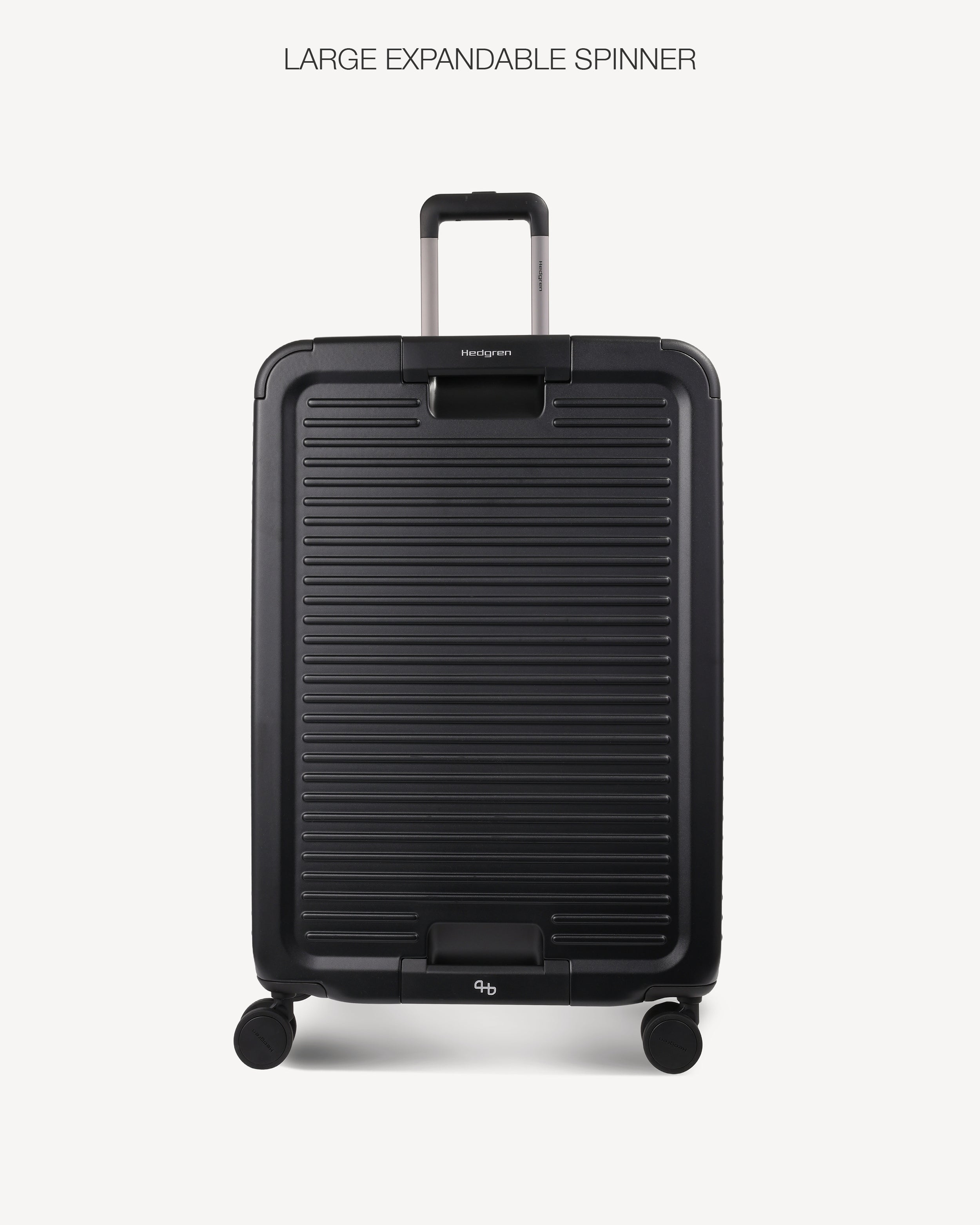 A black hard-shell spinner suitcase with a ribbed front panel and telescoping handle, shown on a light gray background with the text 'LARGE EXPANDABLE SPINNER' above it.