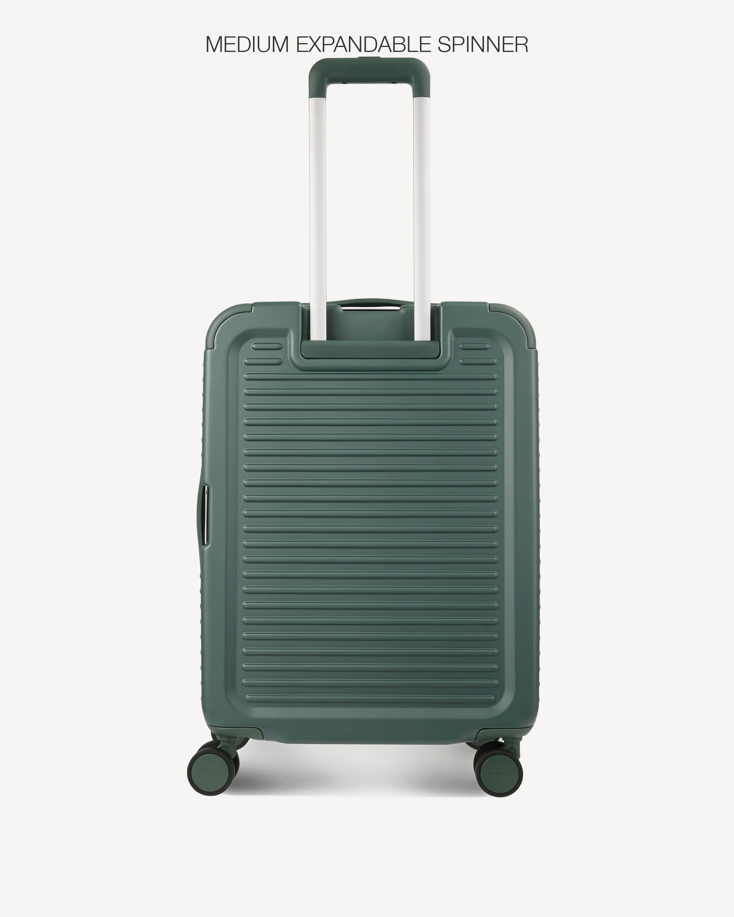 A dark green hardshell spinner suitcase with a telescoping handle extended, shown against a light gray background with the text 'MEDIUM EXPANDABLE SPINNER' at the top.