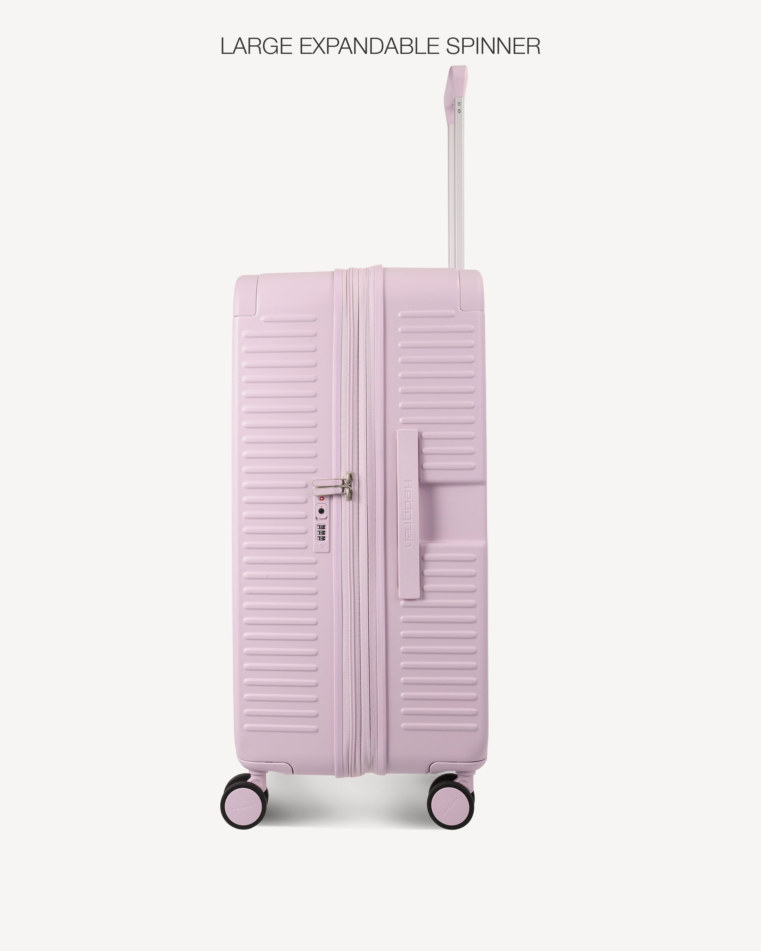 A light pink hard-shell spinner suitcase with a double zipper and telescoping handle, shown on a clean off-white background with the text 'LARGE EXPANDABLE SPINNER' at the top.