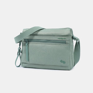 Front angled view of the Eye RFID shoulder bag in lily pad green