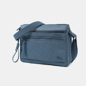 Front angled view of the Eye RFID shoulder bag in vintage indigo