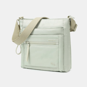 Front angled view of the Orva RFID Crossbody in willow grey