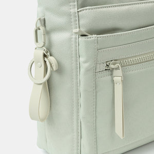 Close up of zipper on the Orva RFID Crossbody in willow grey