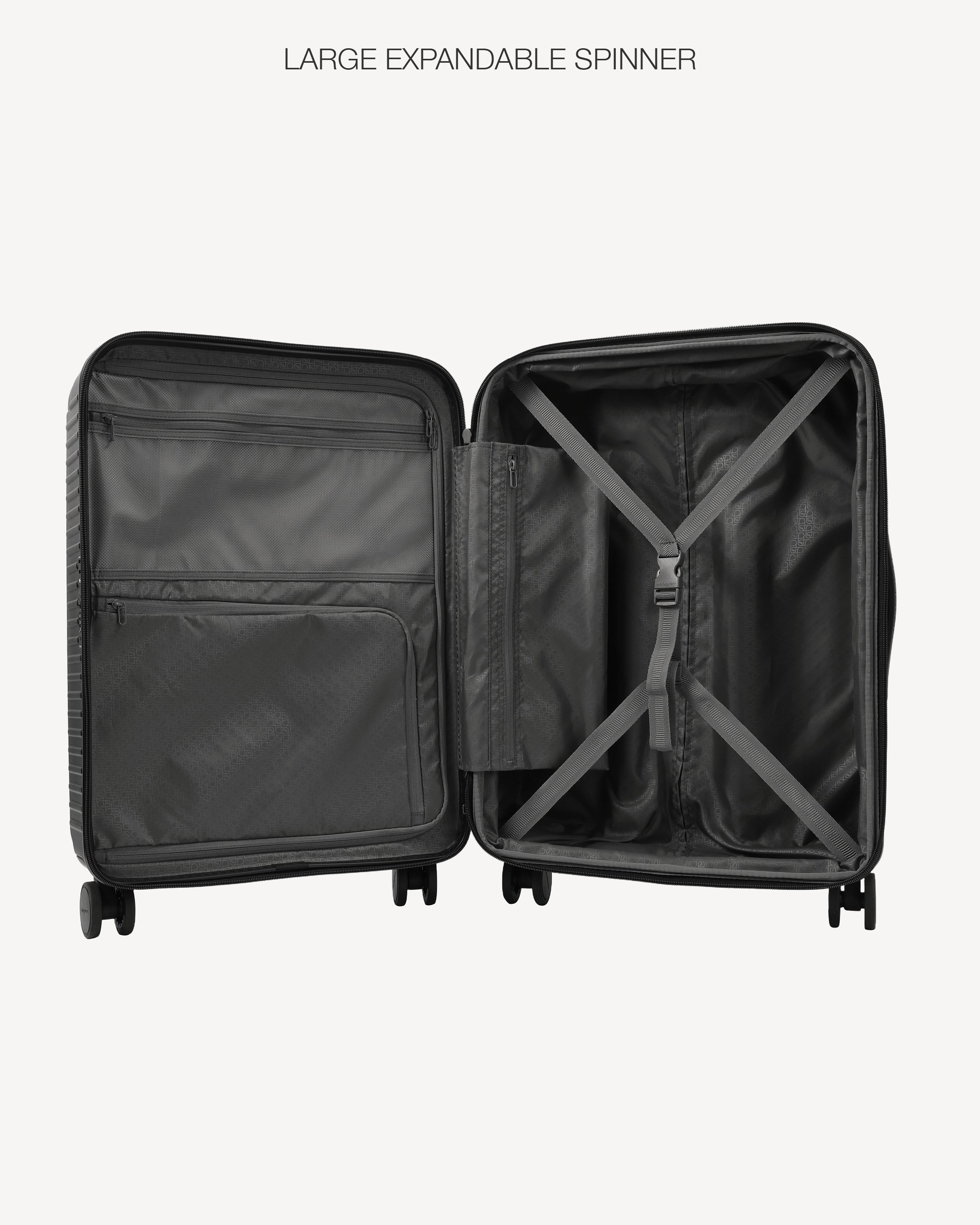 An open black spinner suitcase shown from the inside, with the text 'LARGE EXPANDABLE SPINNER' above it, on a light gray background.
