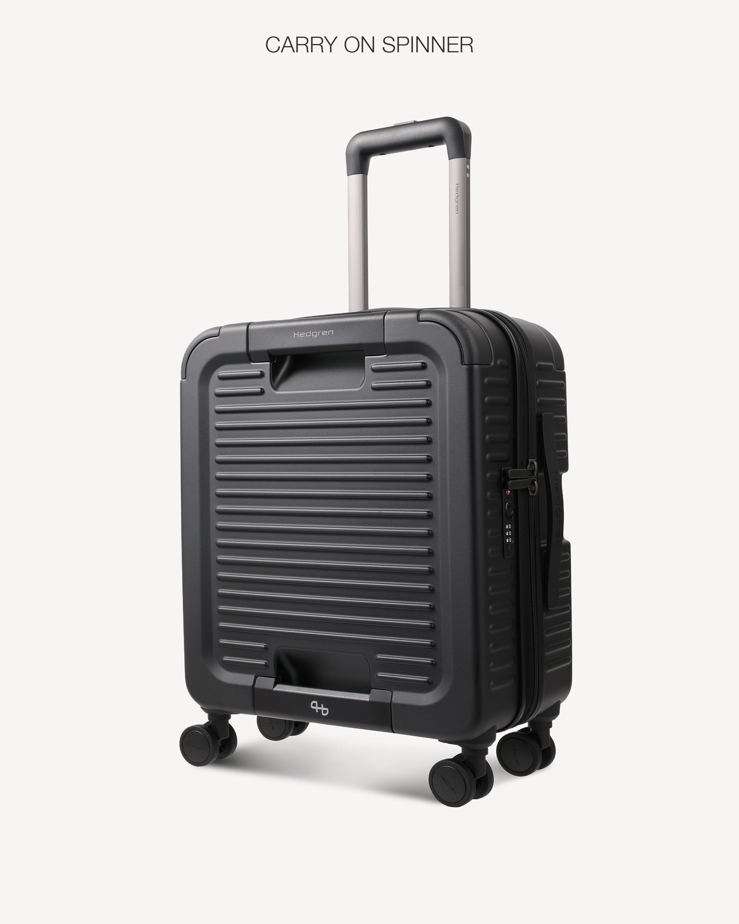 A dark gray ribbed hard-shell spinner suitcase with an extended telescopic handle, shown on a light gray background with the text 'CARRY ON SPINNER' at the top.