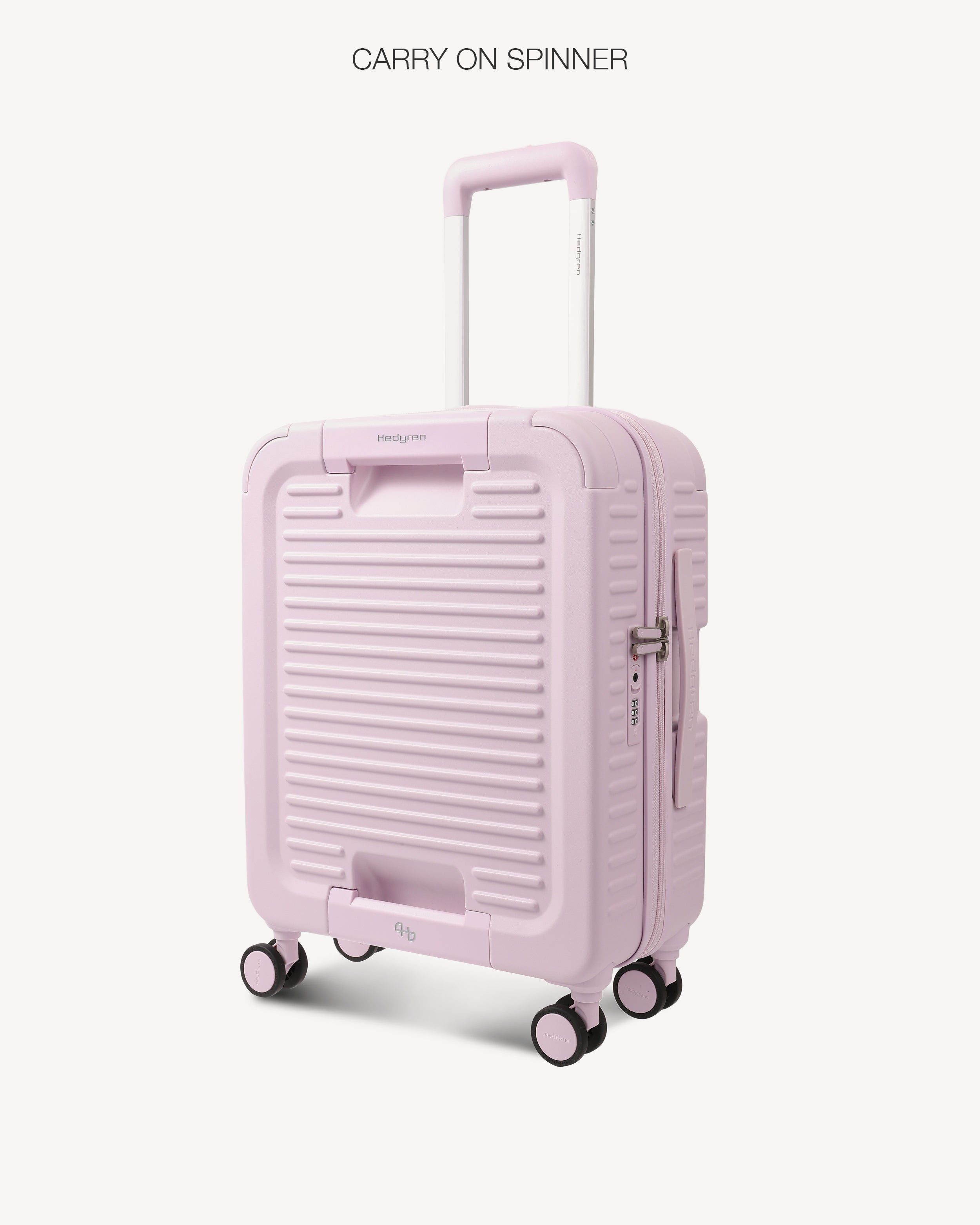 A light pink hard-shell spinner suitcase with a telescoping handle extended, shown on a clean off-white background with the text 'CARRY ON SPINNER' at the top.