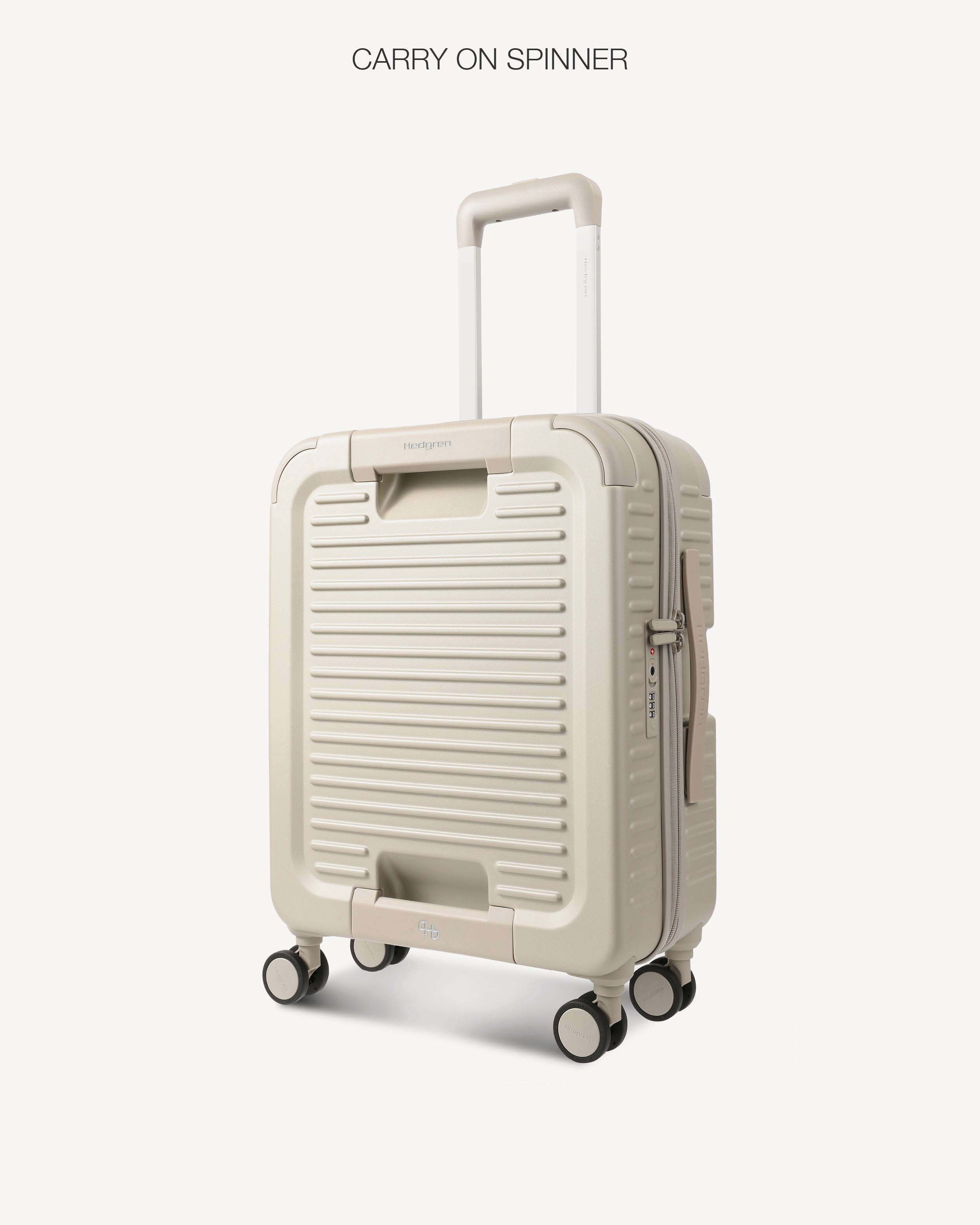 Angled view of a light grey hard-shell spinner suitcase with a telescoping handle extended, shown against a plain light gray background. The text 'CARRY ON SPINNER' is printed at the top.
