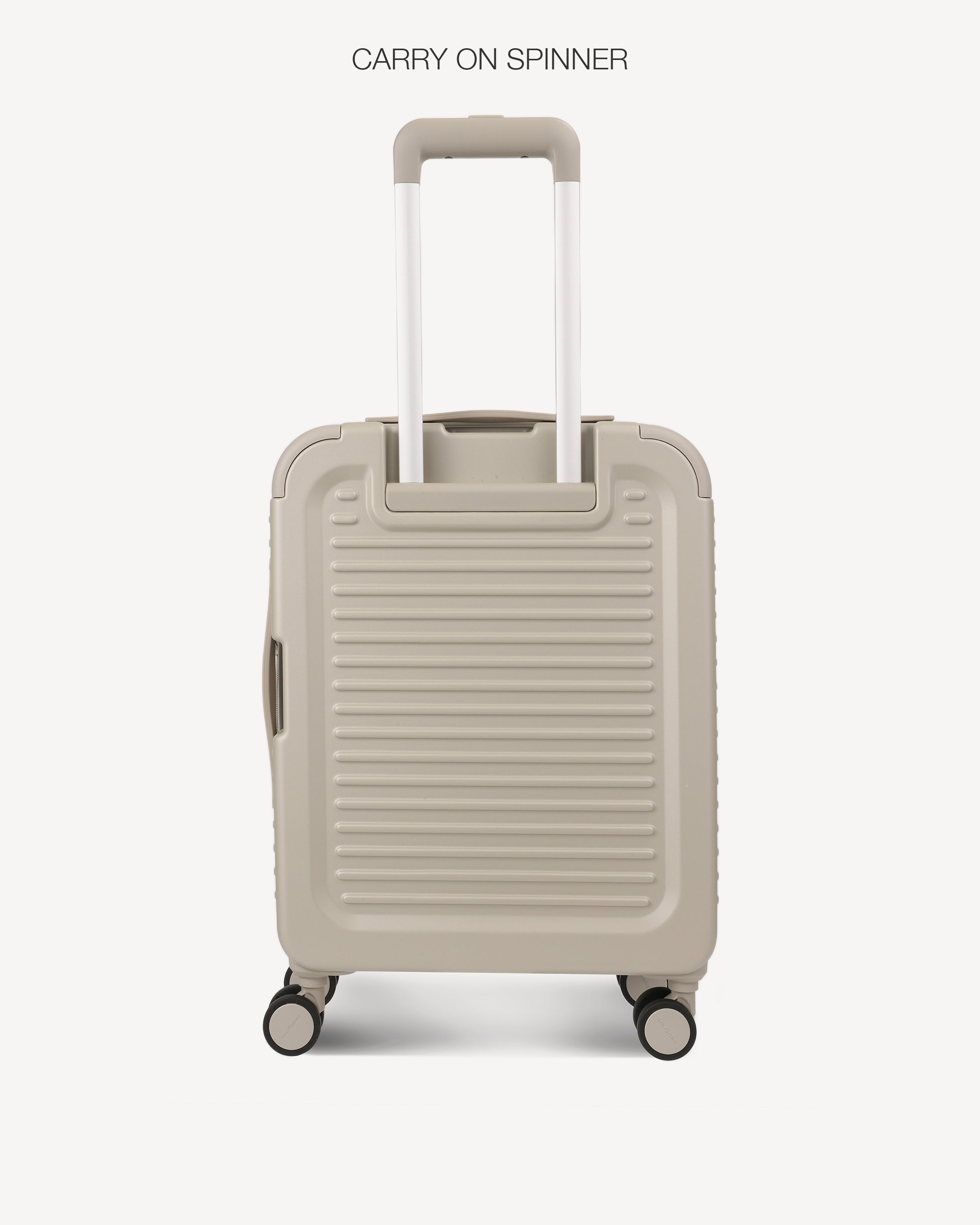 Back of a light grey hard-shell spinner suitcase with a telescoping handle extended, shown against a plain light gray background. The text 'CARRY ON SPINNER' is printed at the top.