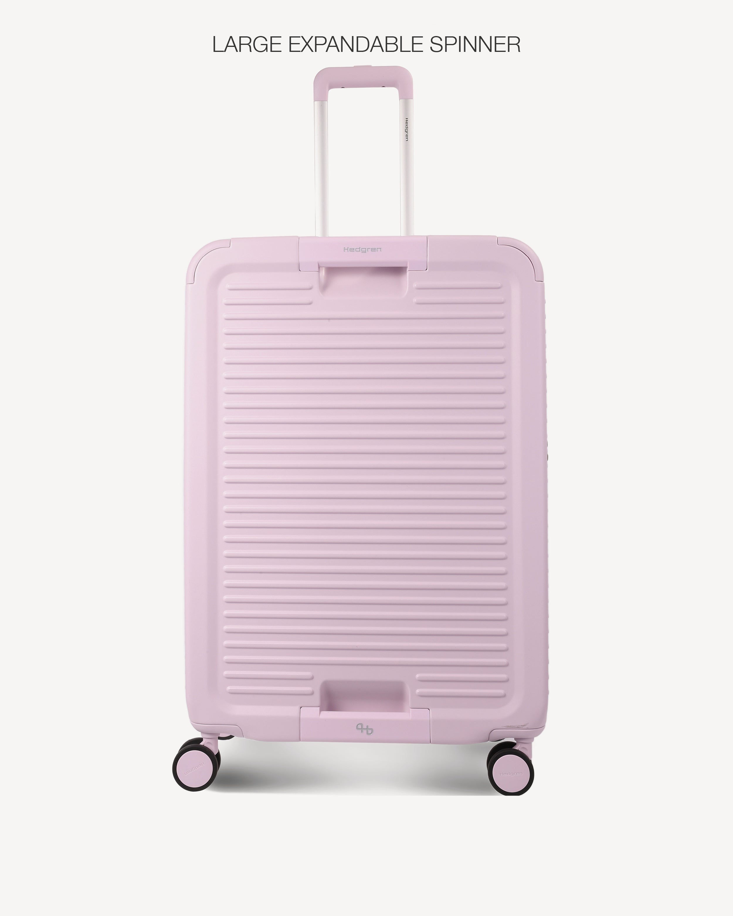 A light pink hard-shell spinner suitcase with a telescoping handle extended, shown against a plain off-white background. The text 'LARGE EXPANDABLE SPINNER' is printed at the top.