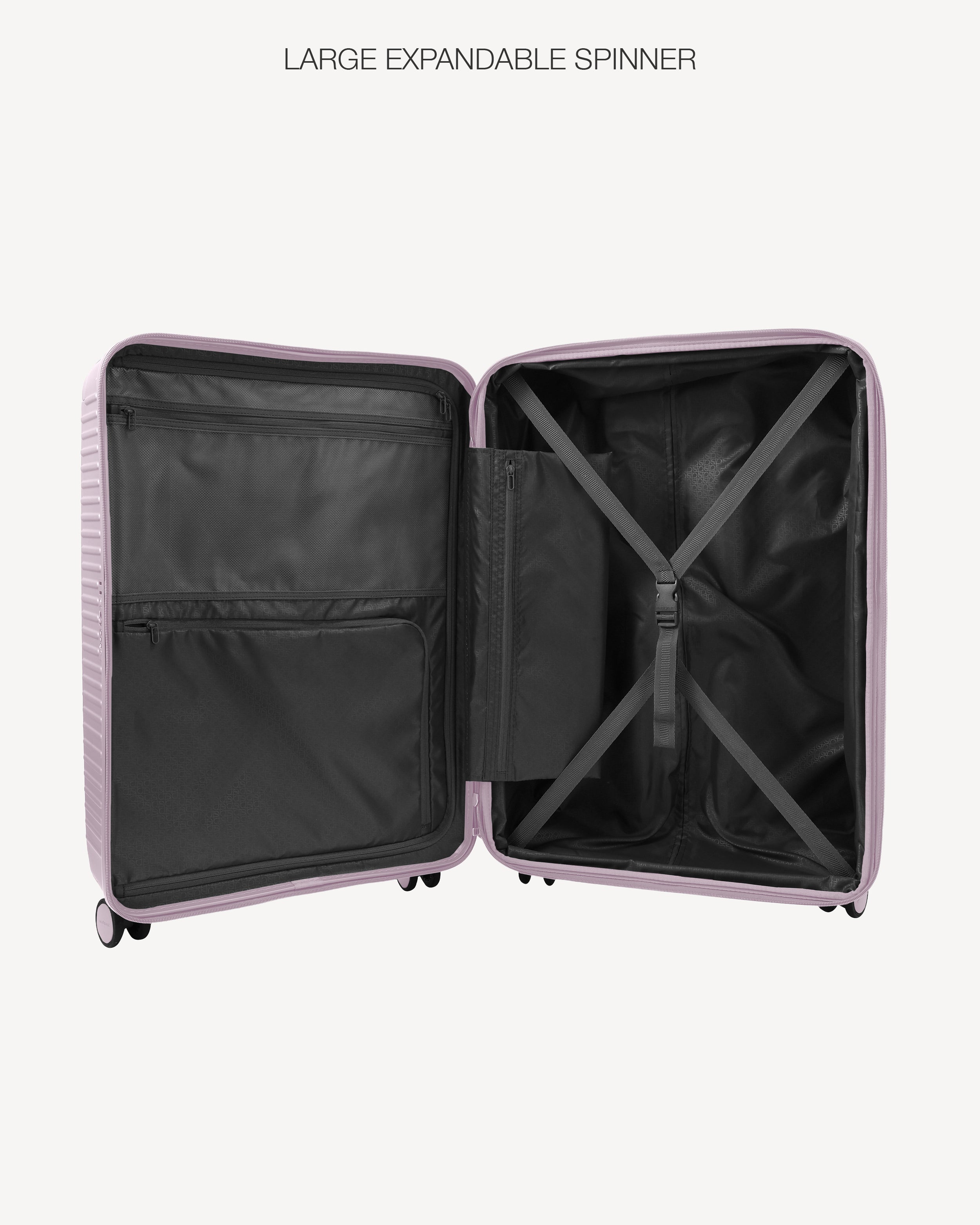 An open hard-shell suitcase shown from the inside, with a light pink exterior and black interior compartments, including a large expandable spinner area. The text 'LARGE EXPANDABLE SPINNER' appears above the product on a light gray background.