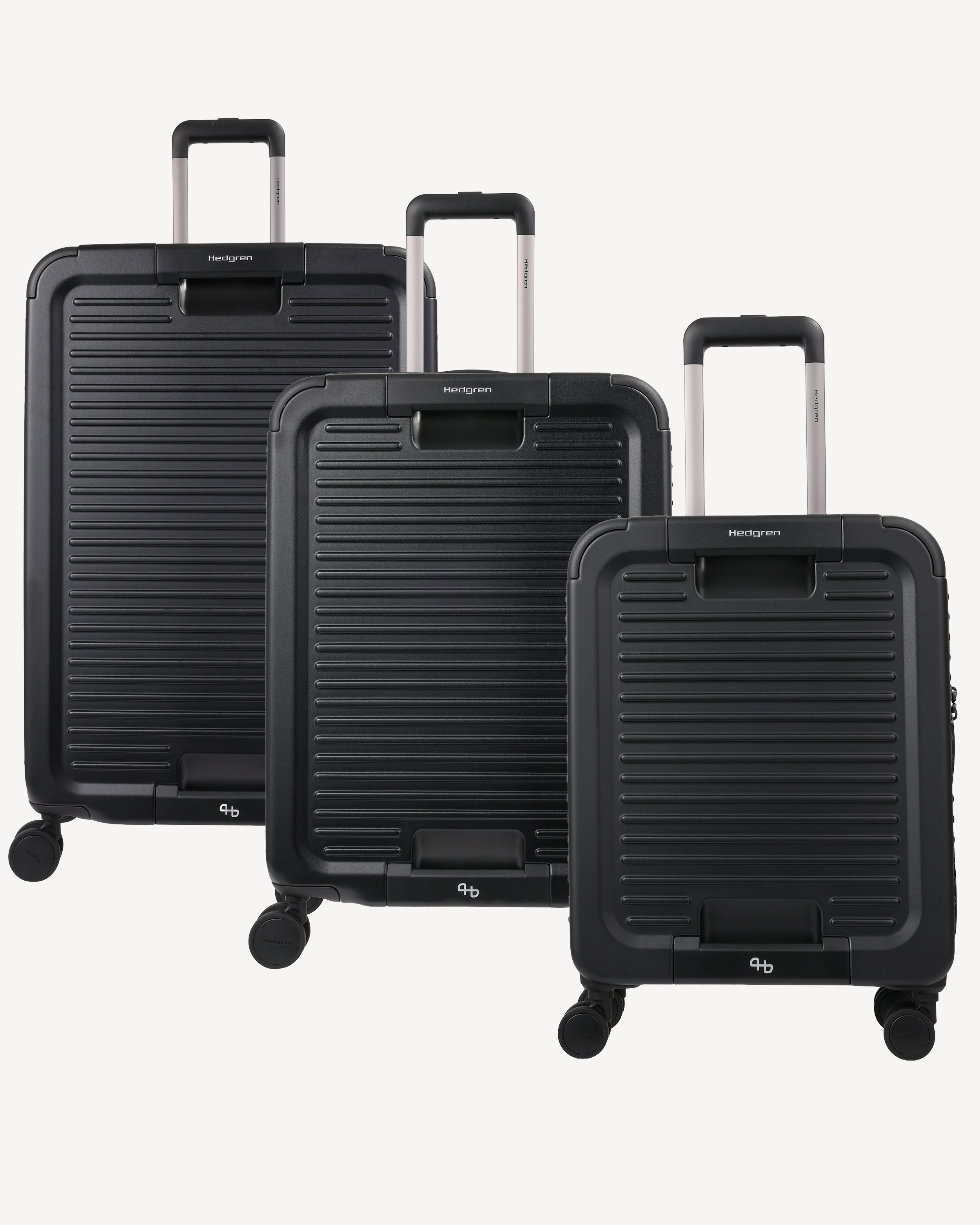 Three-piece black hardshell spinner luggage set with a ribbed texture and telescoping handles, displayed on a light gray background.