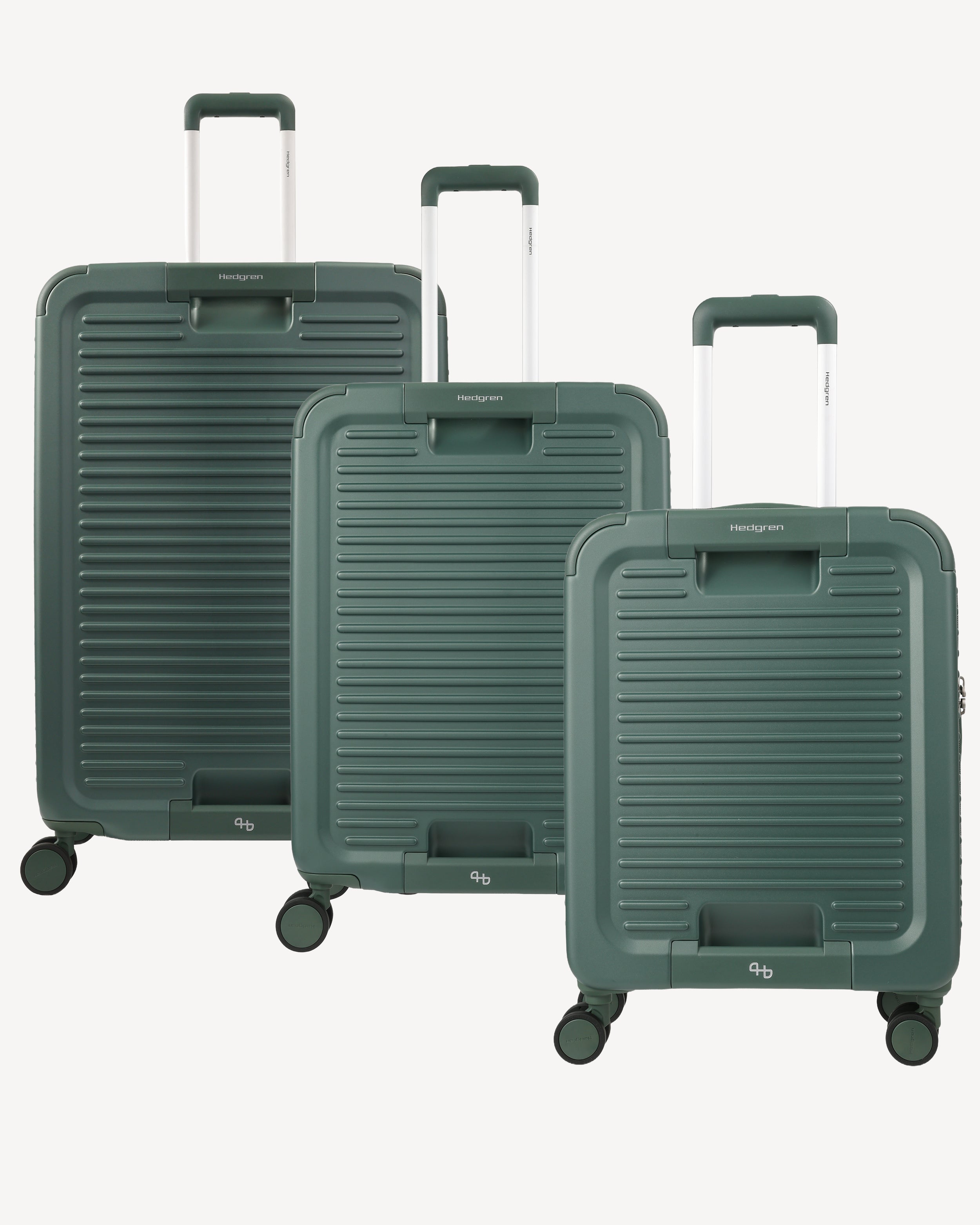 A three-piece luggage set in a dark forest green color, featuring hard-shell suitcases with a ribbed design and telescoping handles, displayed against a light gray background.